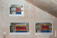 Фото выполненного монтажа 3-х отопительных коллекторных шкафов в стене загородного дома